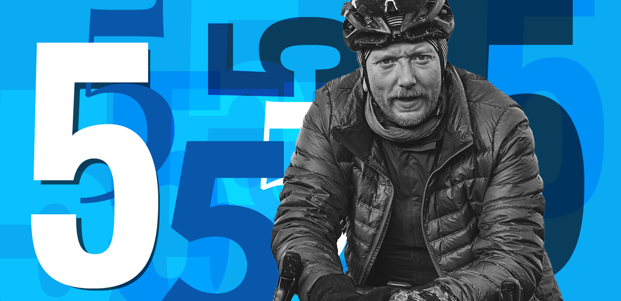 Man on bike infront of a number 5 graphic