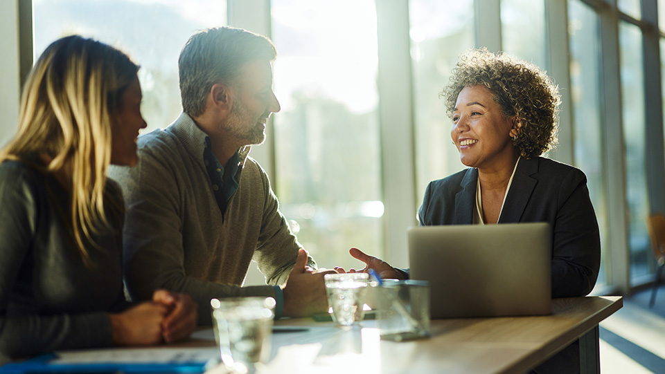 A couple sitting down with a financial advisor